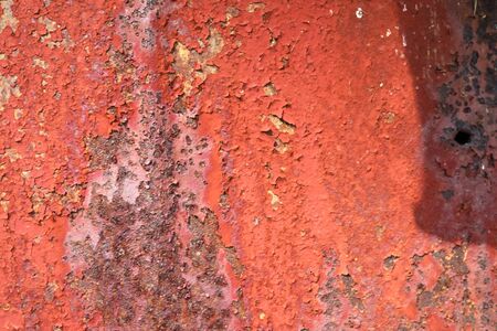 Detailed and colorful close up at cracked and peeling paint on concrete wall textures in high...