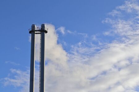 Industry pollution from factories in a blue skyの写真素材
