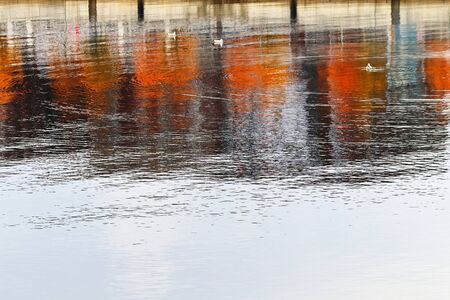 Detailed close up view on water surfaces with waves and ripples and the sunlight reflecting at the...
