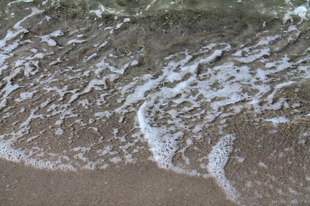 Detailed close up view on water surfaces with waves and ripples and the sunlight reflecting at the...
