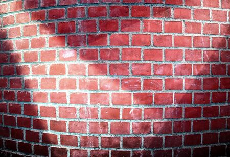 Aged and weathered brick wall textures with bright spotlight illuminationの写真素材
