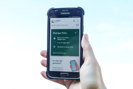 Schleswig-Holstein, Germany - June 19, 2020: Smartphone showing the new corona virus app in german...