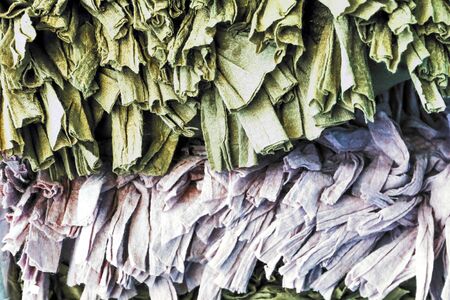 Detailed close up view on samples of cloth and fabrics in different colors found at a fabrics market.の写真素材