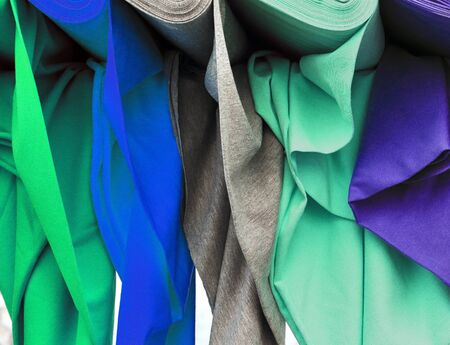 Detailed close up view on samples of cloth and fabrics in different colors found at a fabrics...
