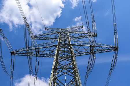 Close up view on a big power pylon transporting electricity in a countryside area in Europe