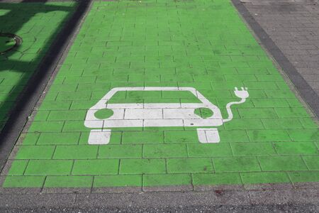 Sign of a loading station for electric cars painted on a parking lotの写真素材