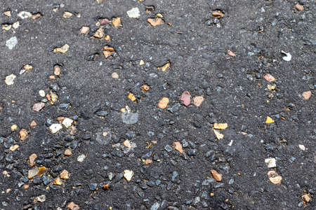 Detailed view on asphalt surfaces of different streets and roads with cracks in a close upの写真素材