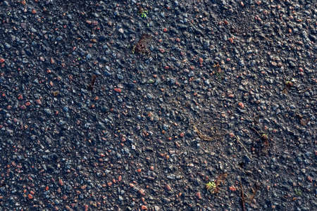 Detailed view on asphalt surfaces of different streets and roads with cracks in a close upの写真素材