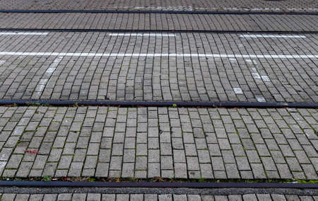 Detailed view on asphalt surfaces of different streets and roads with cracks in a close upの写真素材