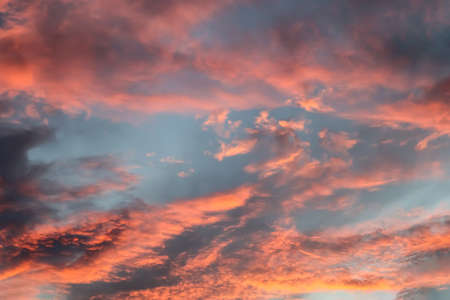 Beautiful panorama of orange and yellow clouds at sunrise and sunset in a blue sky