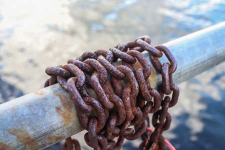Rusty chain around metal bars at the port of Kielの写真素材