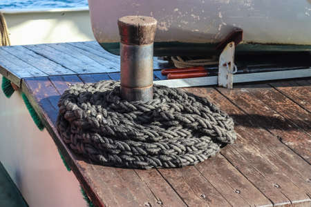 Detailed close up detail of ropes and cordage in the rigging of an old wooden vintage sailboat.