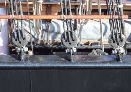 Detailed close up detail of ropes and cordage in the rigging of an old wooden vintage sailboat.
