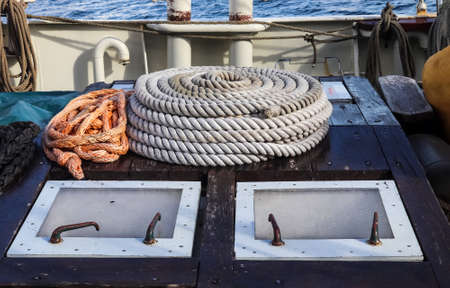 Detailed close up detail of ropes and cordage in the rigging of an old wooden vintage sailboat.の写真素材