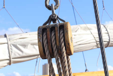 Detailed close up detail of ropes and cordage in the rigging of an old wooden vintage sailboat.の写真素材