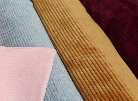 Detailed close up view on samples of cloth and fabrics in different colors found at a fabrics market.の写真素材