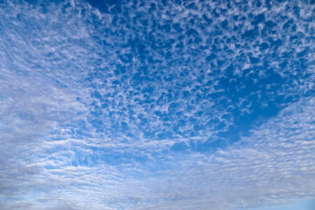 Beautiful fluffy white beautiful cloud formations in a deep blue summer sky