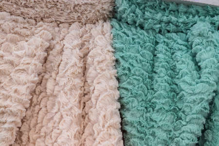 Detailed close up view on samples of cloth and fabrics in different colors found at a fabrics...