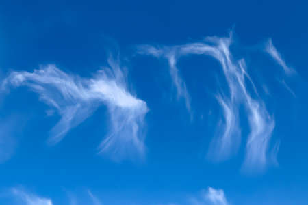 Stunning cirrus cloud formation panorama in a deep blue summer sky seen over Europeの写真素材