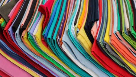 Detailed close up view on samples of cloth and fabrics in different colors found at a fabrics market.の写真素材