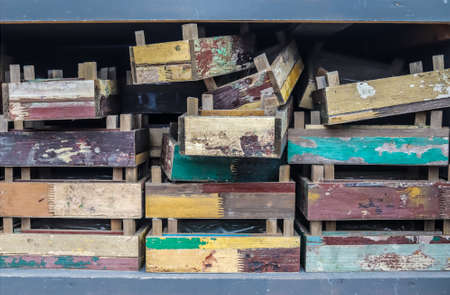 Vintage wooden crates in a shelf for sale in a small shop