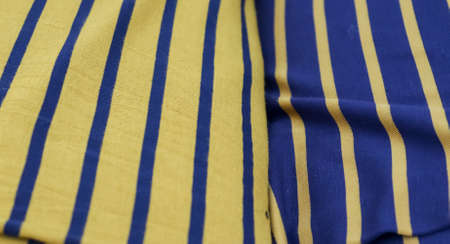 Detailed close up view on samples of cloth and fabrics in different colors found at a fabrics...