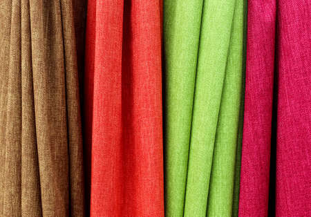Detailed close up view on samples of cloth and fabrics in different colors found at a fabrics...