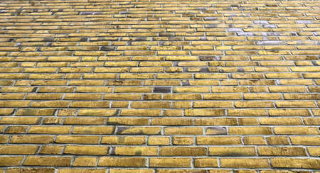 Detailed view at a colorful old and weathered brick wall texture. Panoramic background.の写真素材