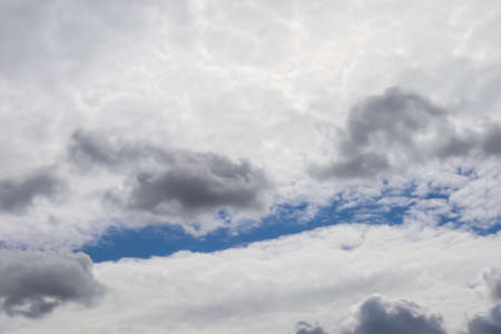 Stunning mixed cloud formation panorama in a deep blue summer sky.