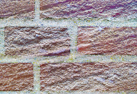 Detailed close up view on very old and weathered brick walls with cracks found in London