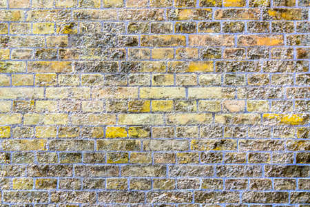 Detailed close up view on very old and weathered brick walls with cracks found in London