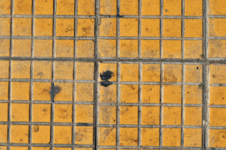 Detailed close up texture on structured floor tiles on a groundの写真素材