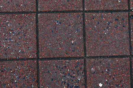 Detailed close up texture on structured floor tiles on a ground