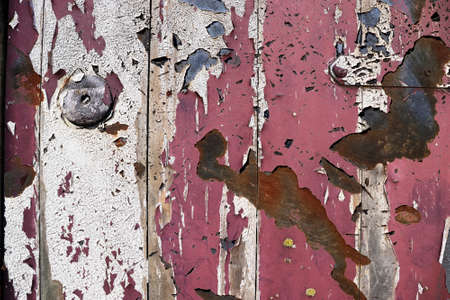 Detailed and colorful close up at cracked and peeling paint on concrete wall textures in high...