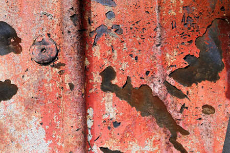 Detailed and colorful close up at cracked and peeling paint on concrete wall textures in high...