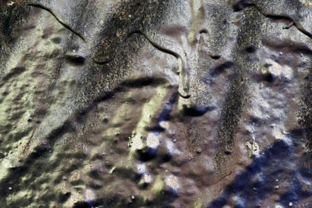 Detailed close up view of aged and weathered concrete walls with cracks and paint in high resolution