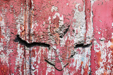 Detailed close up view of aged and weathered concrete walls with cracks and paint in high resolutionの写真素材
