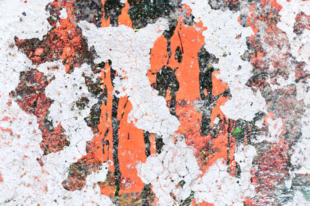 Detailed close up view of aged and weathered concrete walls with cracks and paint in high resolutionの写真素材