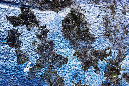 Detailed close up view of aged and weathered concrete walls with cracks and paint in high resolutionの写真素材
