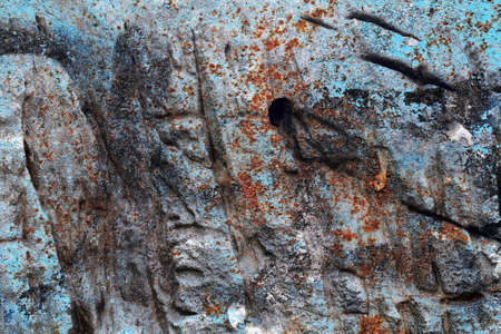 Detailed close up view of aged and weathered concrete walls with cracks and paint in high resolution