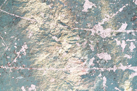 Detailed close up view of aged and weathered concrete walls with cracks and paint in high resolution
