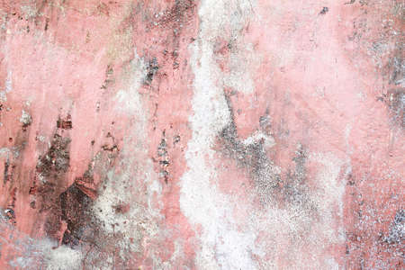 Detailed close up view of aged and weathered concrete walls with cracks and paint in high resolutionの写真素材