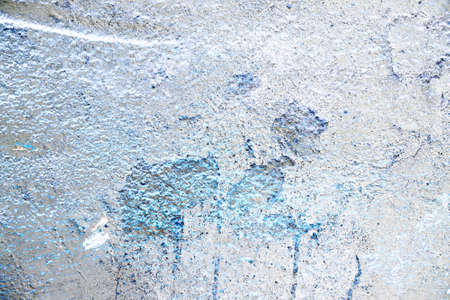 Detailed close up view of aged and weathered concrete walls with cracks and paint in high resolutionの写真素材