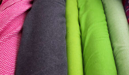 Detailed close up view on samples of cloth and fabrics in different colors found at a fabrics...