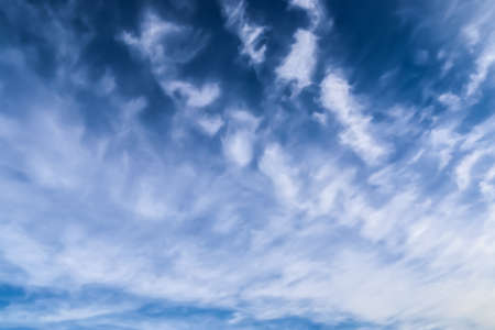 Stunning cirrus cloud formation panorama in a deep blue summer sky seen over Europeの写真素材