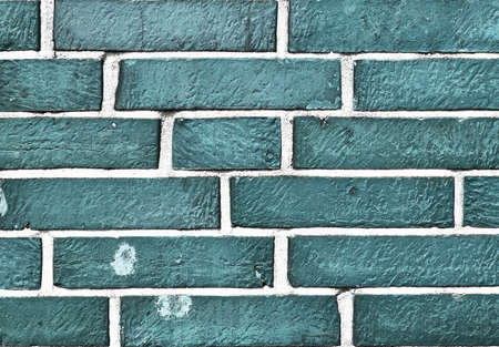 Detailed view at a colorful old and weathered brick wall texture. Panoramic background.