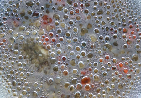 Hot water drops condensating at a glass pot cover during cookingの写真素材