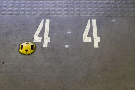 Numbers painted on concrete and asphalt textured surfacesの写真素材