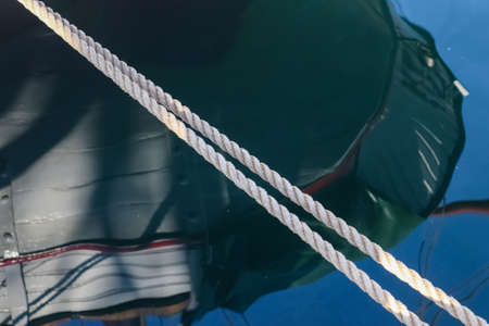 Detailed close up detail of ropes and cordage in the rigging of an old wooden vintage sailboat.の写真素材
