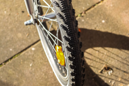 Selective focus close up view at a bicycle wheel with metal spokes